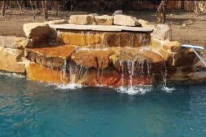 Pool features boulder waterfall